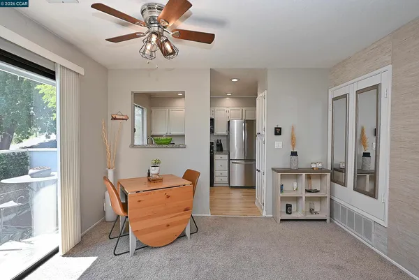 a living room with stainless steel appliances kitchen island furniture and a chandelier