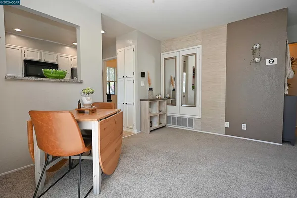 a view of kitchen with furniture and a refrigerator