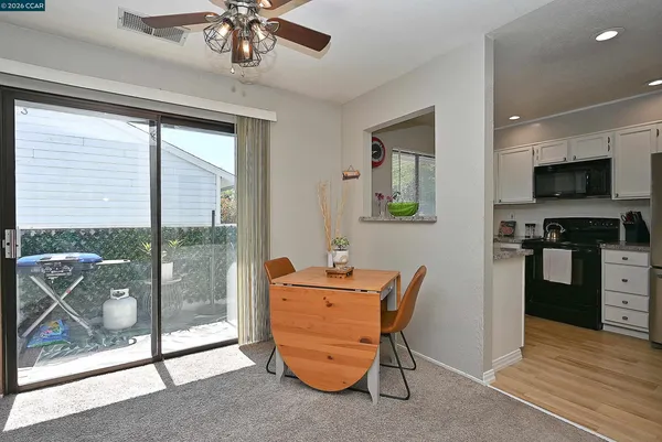 a dining room with furniture and front door view