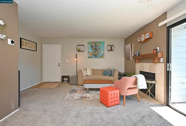 a living room with furniture and a fireplace