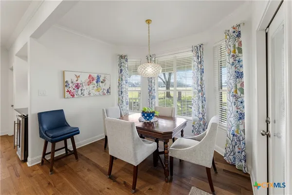 a room with furniture a baby crib and a book shelf