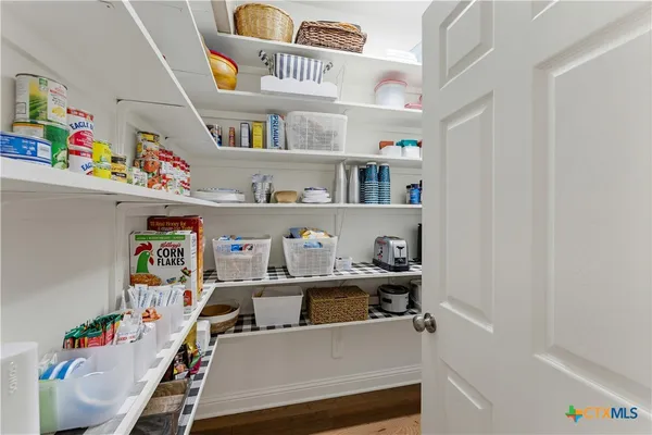 a spacious bedroom with a bed and dresser