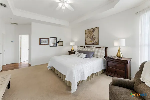 a bathroom with a granite countertop tub sink and mirror