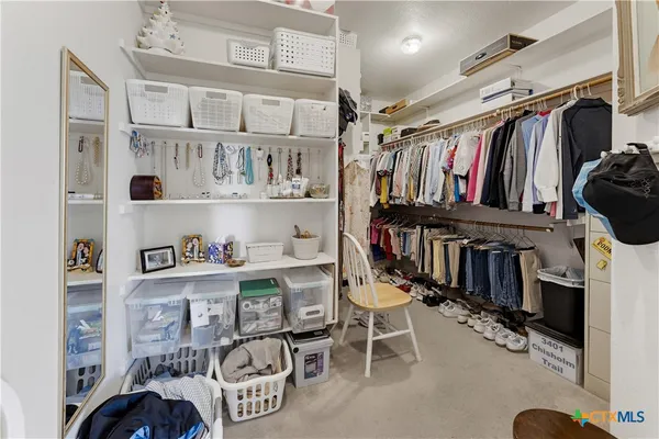 a view of a hallway with furniture and a refrigerator