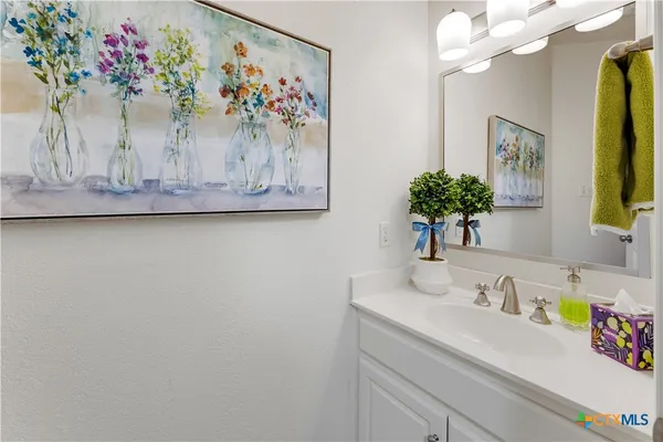 a bedroom with a bed couch and a chandelier