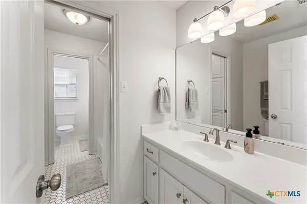 a bathroom with a sink a mirror and a bathtub