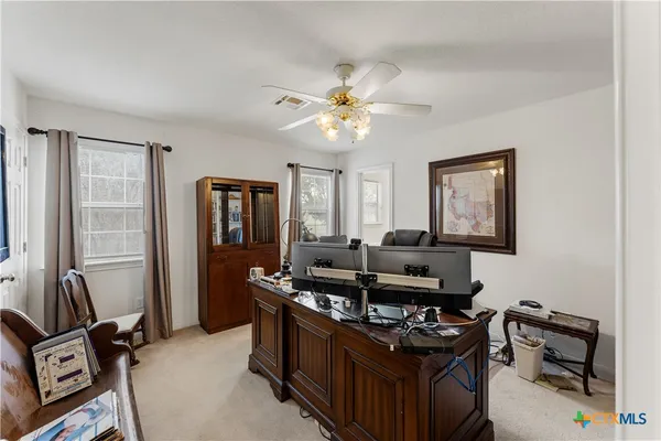 a view of a workspace with a bookshelf