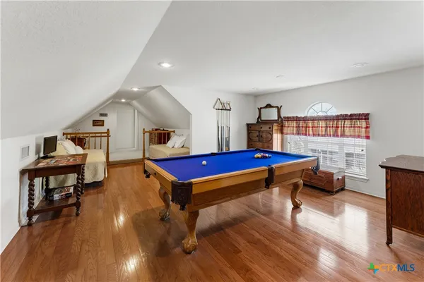 a bed room with a bed and a book shelf