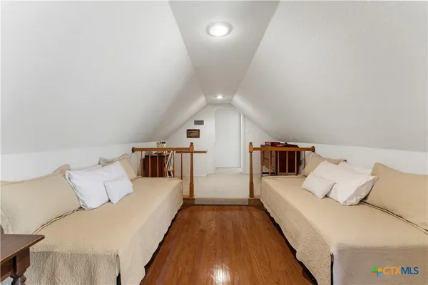 a view of a porch with furniture and wooden floor