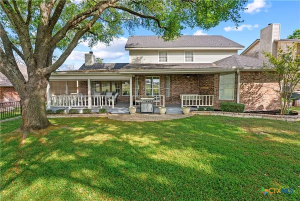 a view of a house with a yard porch and sitting area