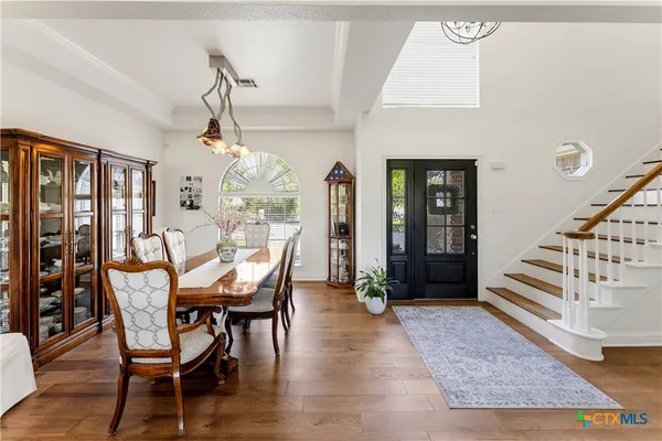 a view of a dining room with furniture window and wooden floor