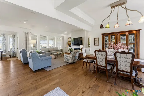a large living room with furniture a fireplace and a chandelier
