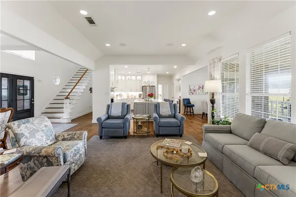 a living room with furniture and white couches