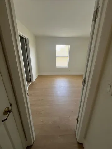 a bathroom with a glass door shower and a sink