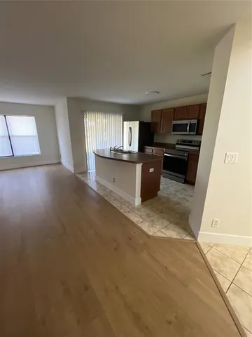 a kitchen with a sink and a stove top oven
