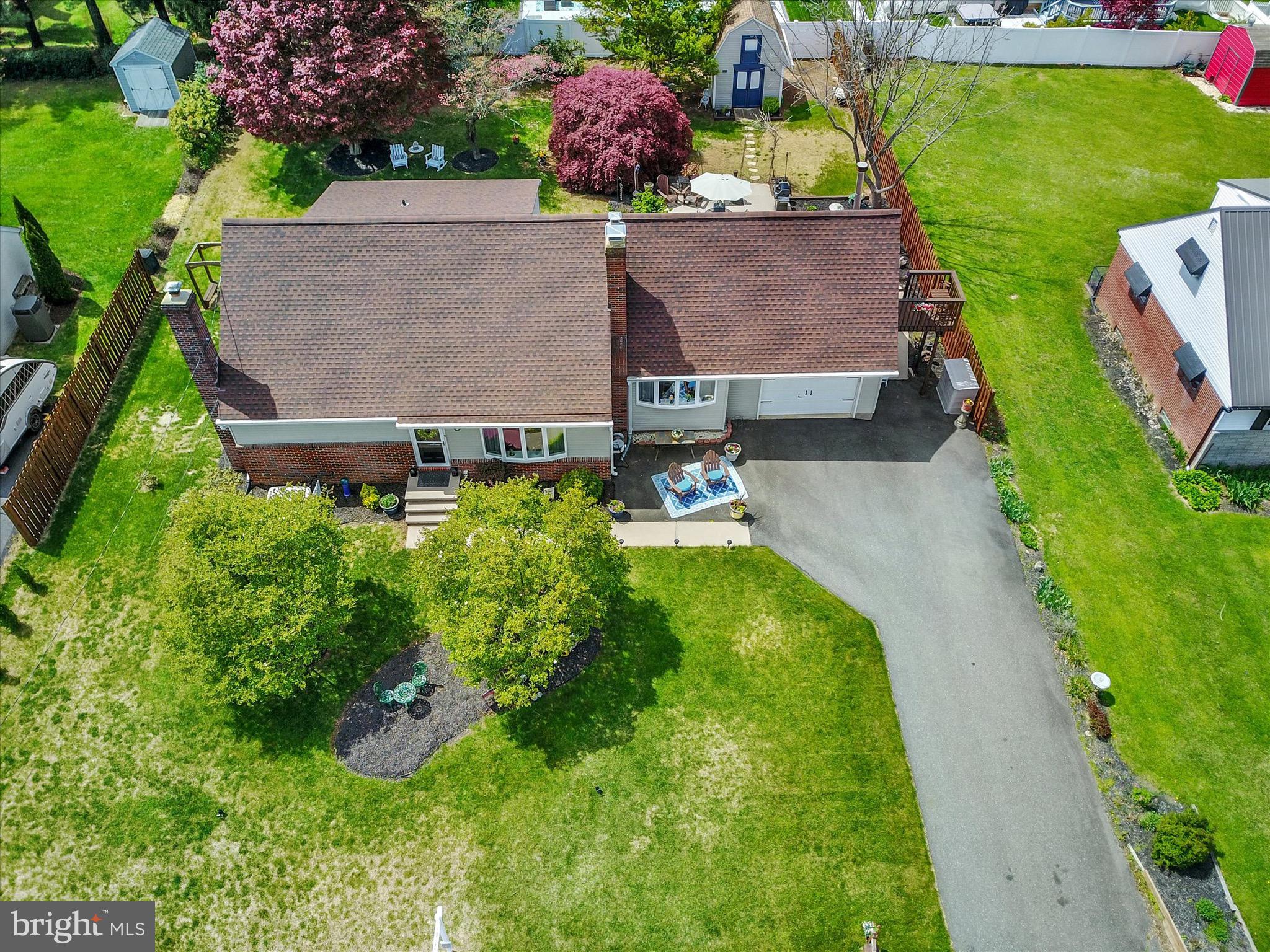 an aerial view of a house with garden space and street view