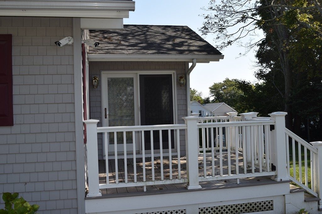 381 Albert Street Fall River, MA 02721 - Photo 3 of 21 a view of a wooden house with a small yard