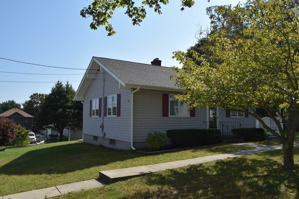 381 Albert Street Fall River, MA 02721 - Photo 5 of 21 a front view of a house with a yard and garage