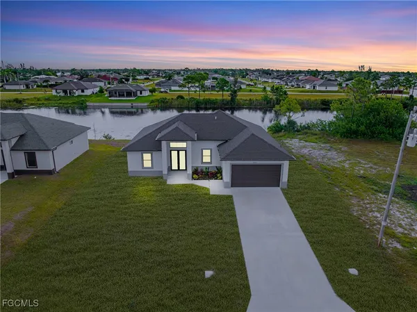an aerial view of residential houses with outdoor space and trees