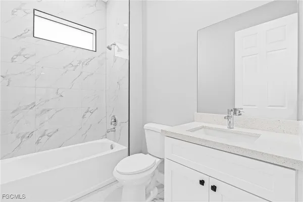 a bathroom with a sink a toilet and a bathtub