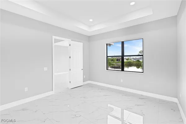 an empty room with windows and closet