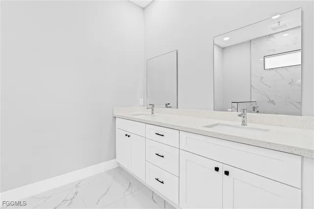 a bathroom with double sink and a mirror