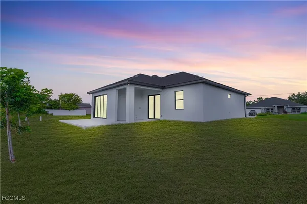 a backyard of a house with lots of green space and mountain view