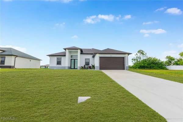 a front view of a house with a garden