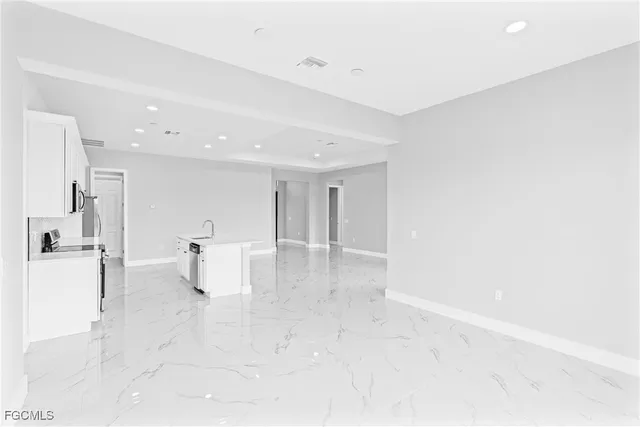 a view of kitchen with furniture and refrigerator