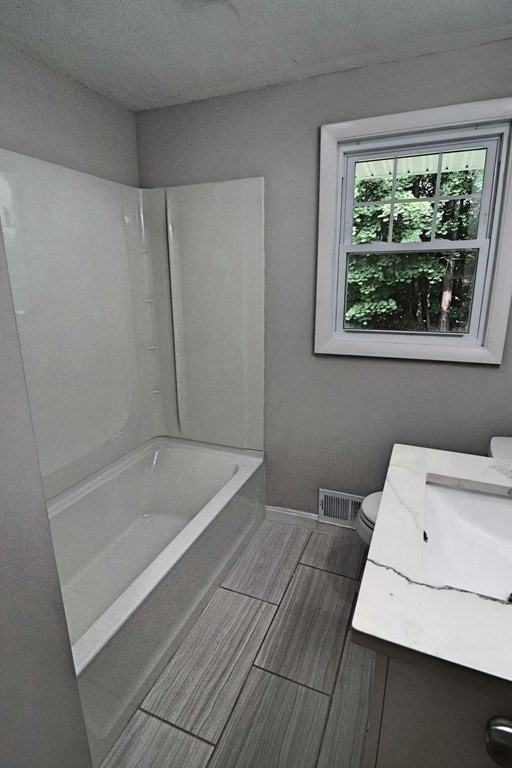 10 Richard Road Hudson, MA 01749 - Photo 22 of 42 a bathroom with a bathtub and a window