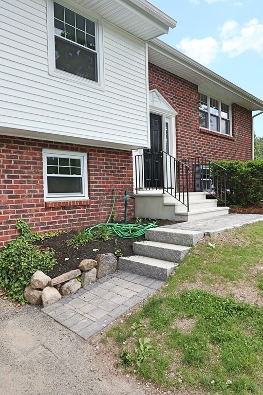 10 Richard Road Hudson, MA 01749 - Photo 3 of 42 a front view of a house with a yard