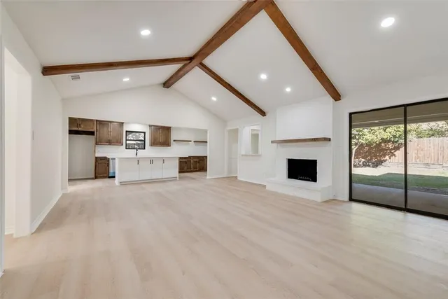 a view of open kitchen with a sink and a fireplace