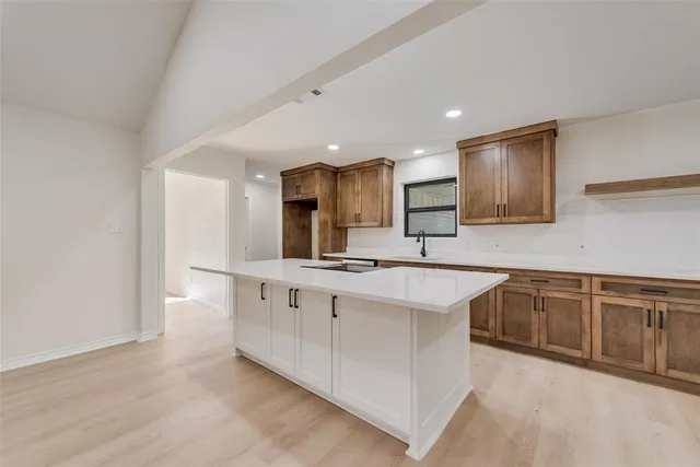 a large kitchen with stainless steel appliances granite countertop a sink and cabinets