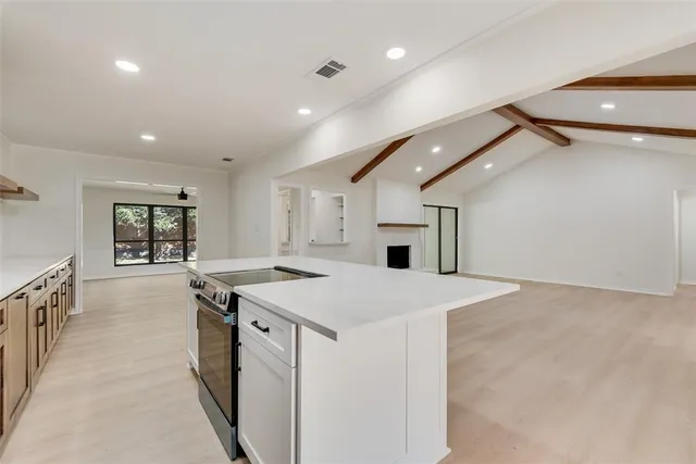 a kitchen with a stove a sink and a refrigerator