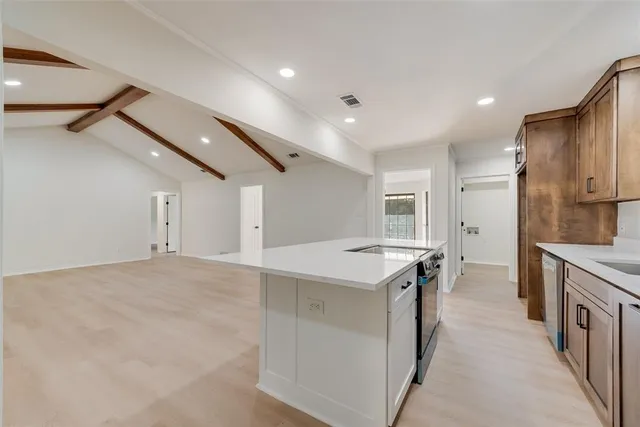 a kitchen with a sink stove and refrigerator