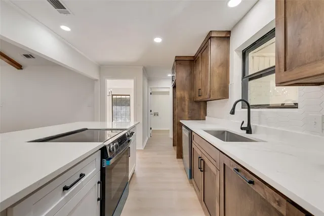 a kitchen with a sink and cabinets