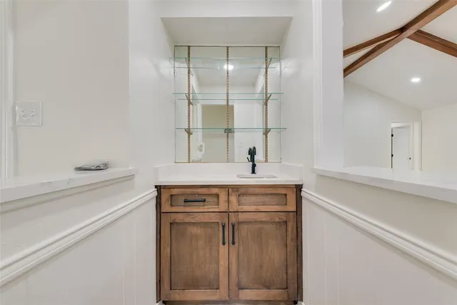 a view of cabinets a sink and a stove in a kitchen