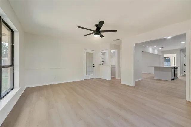 a view of a livingroom with a ceiling fan and window