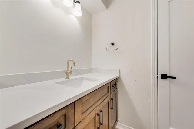 a close view of a sink and cabinets