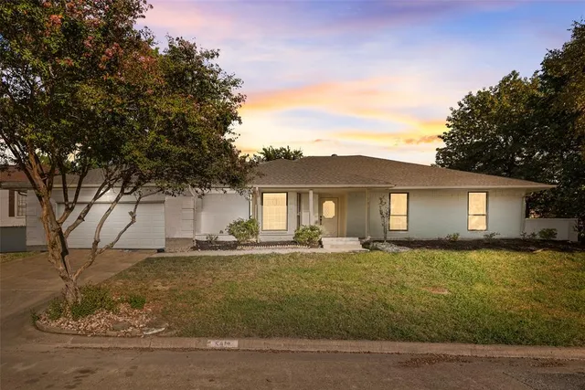 a house that has a tree in front of it