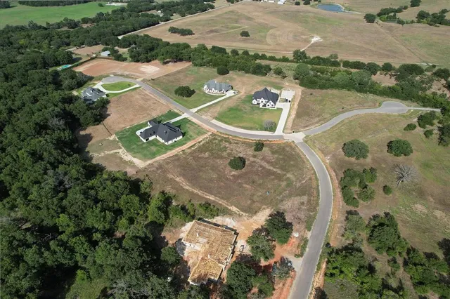 an aerial view of a house with yard swimming pool and outdoor seating