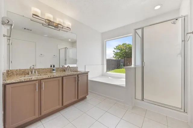 a view of a bathroom with a tub and a shower