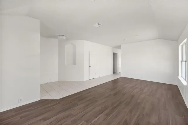 an empty room with wooden floor