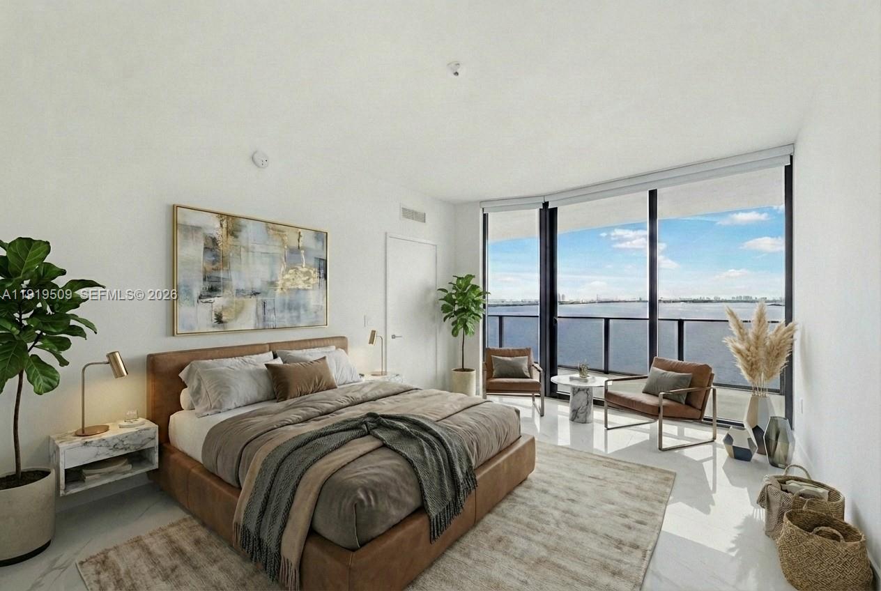 700 Northeast 24th Street, Unit 1101 Miami, FL 33137 - Photo 15 of 66 a bedroom with a bed and a potted plant