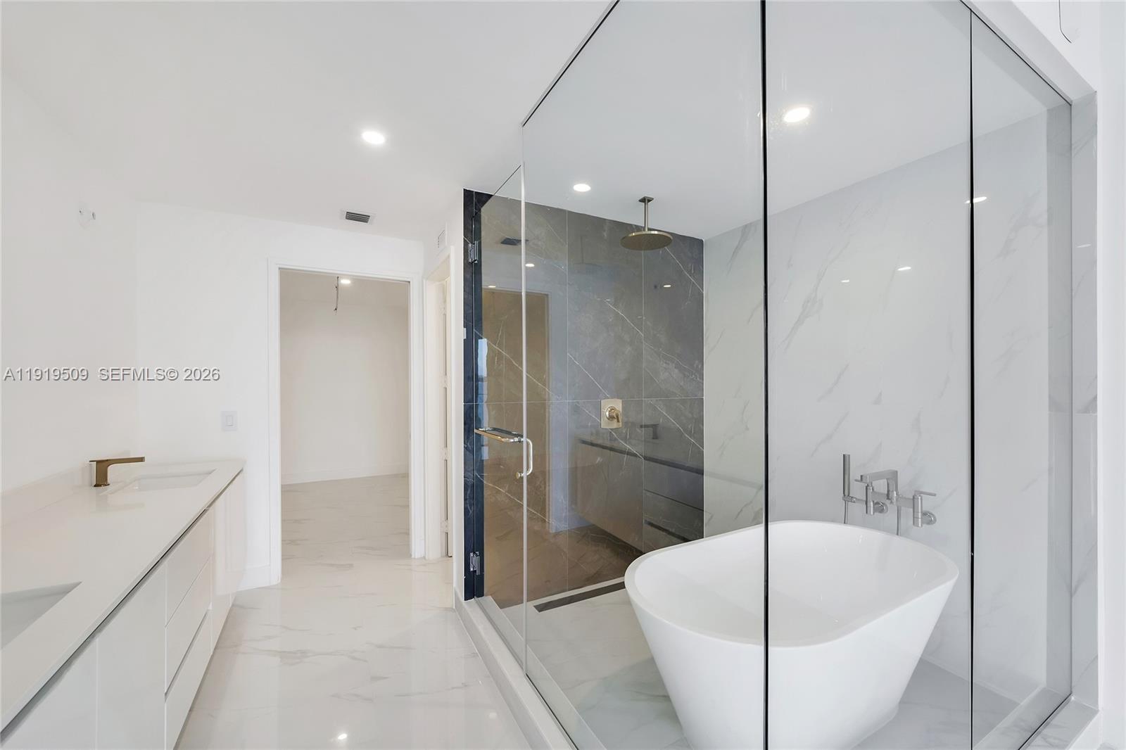 700 Northeast 24th Street, Unit 1101 Miami, FL 33137 - Photo 19 of 66 a bathroom with a tub a sink and a shower