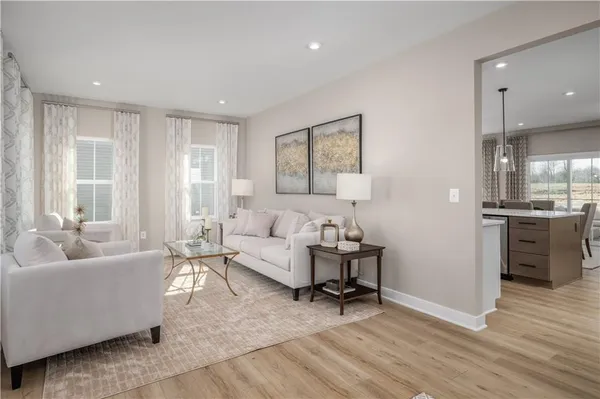 a living room with furniture and a kitchen