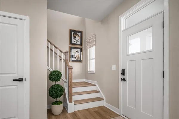 a view of entryway and hall with wooden floor