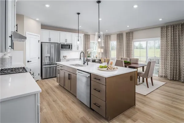 a large kitchen with stainless steel appliances kitchen island a large island in the center