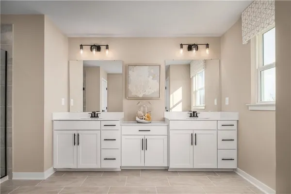 a spacious bathroom with a double vanity sink and a window