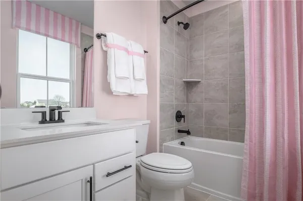 a bathroom with a sink mirror toilet and bathtub